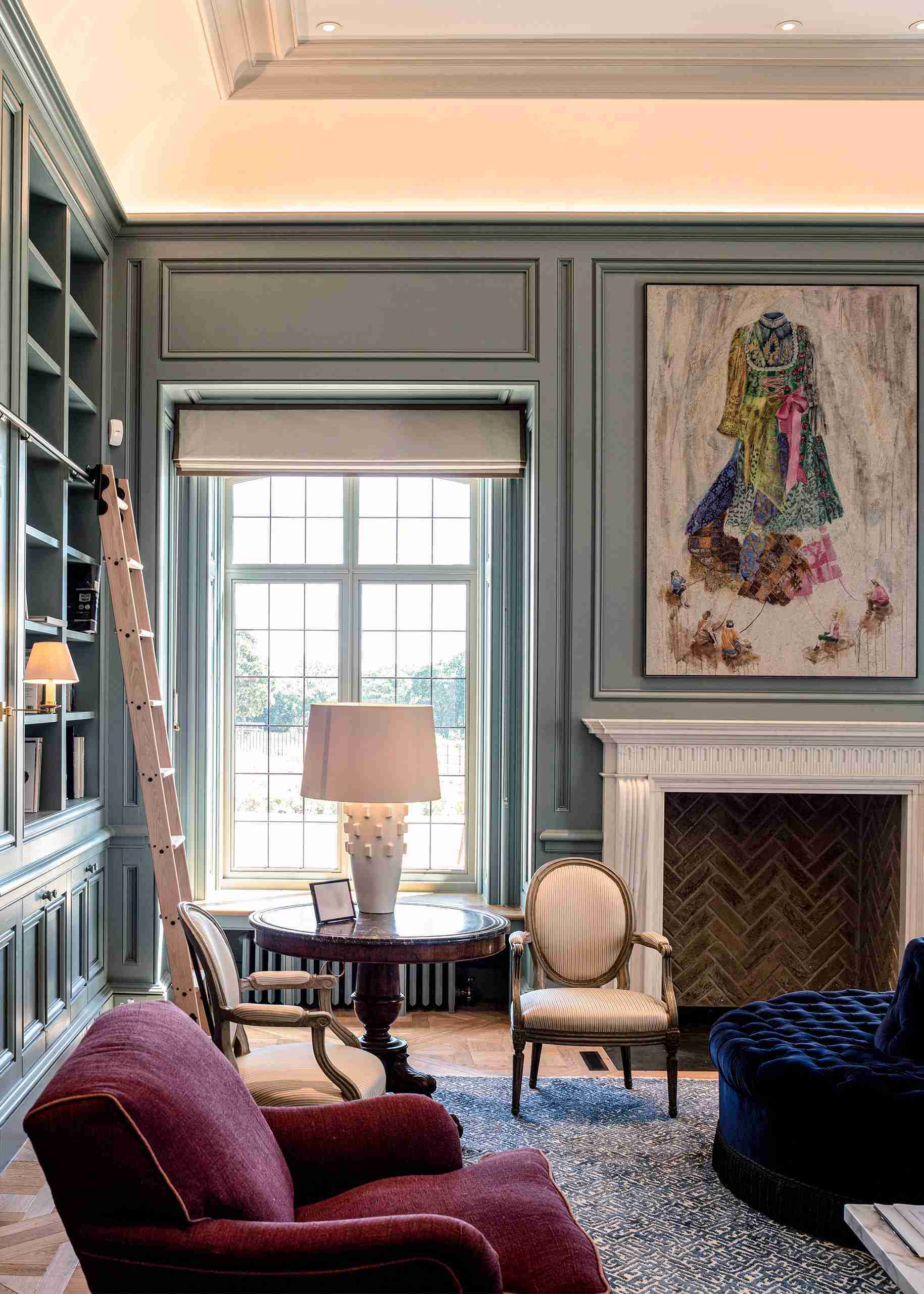 Bespoke Joinery Package for Luxurious living room with bespoke built-in bookshelves, wall paneling, and timber fireplace.