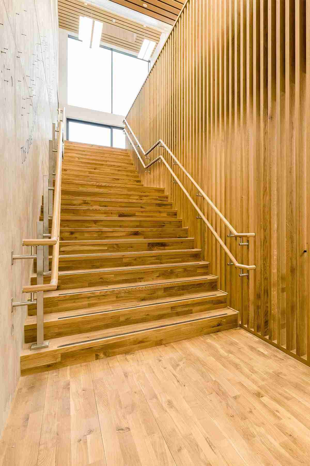 Custom built stairway with matching wooden panelling in an Oxford based Music School.