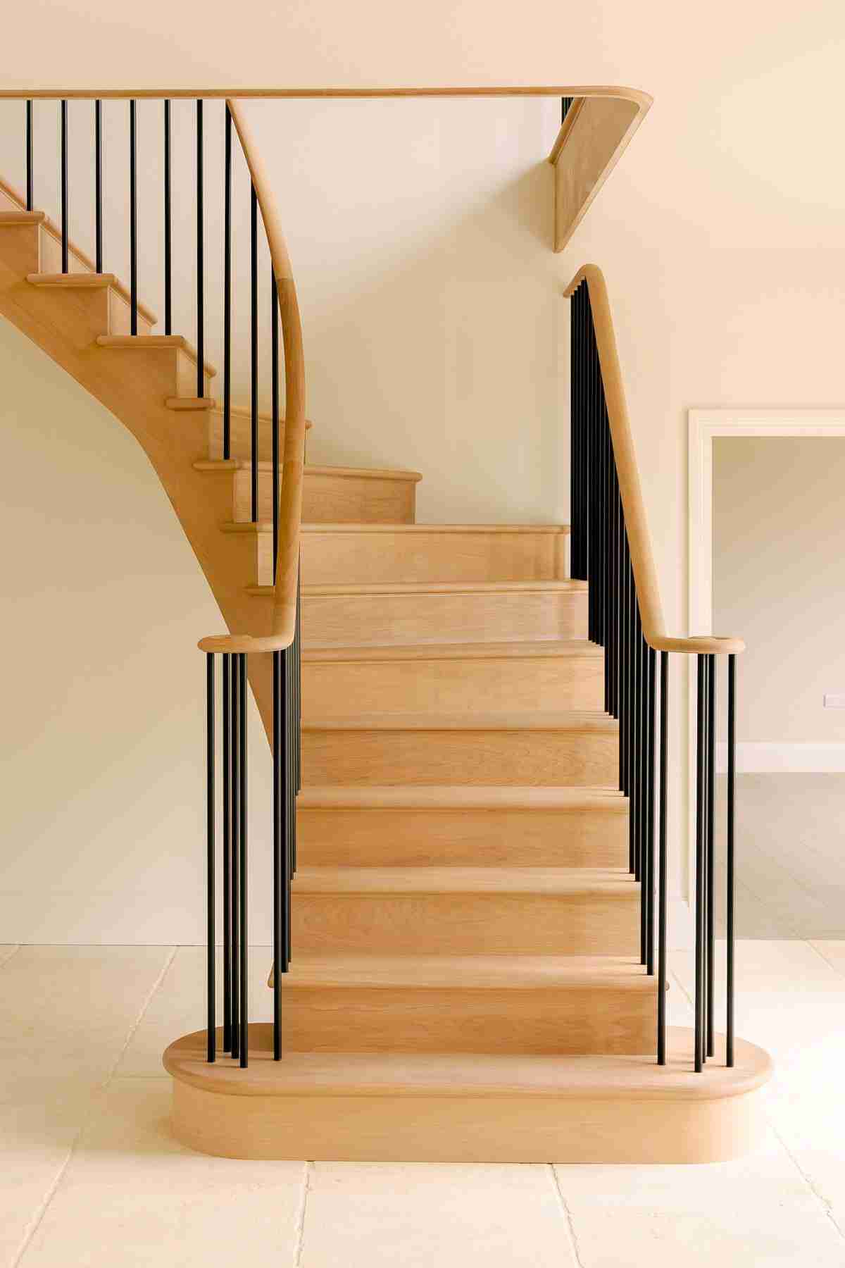 Custom crafted ground to first floor curved oak staircase.