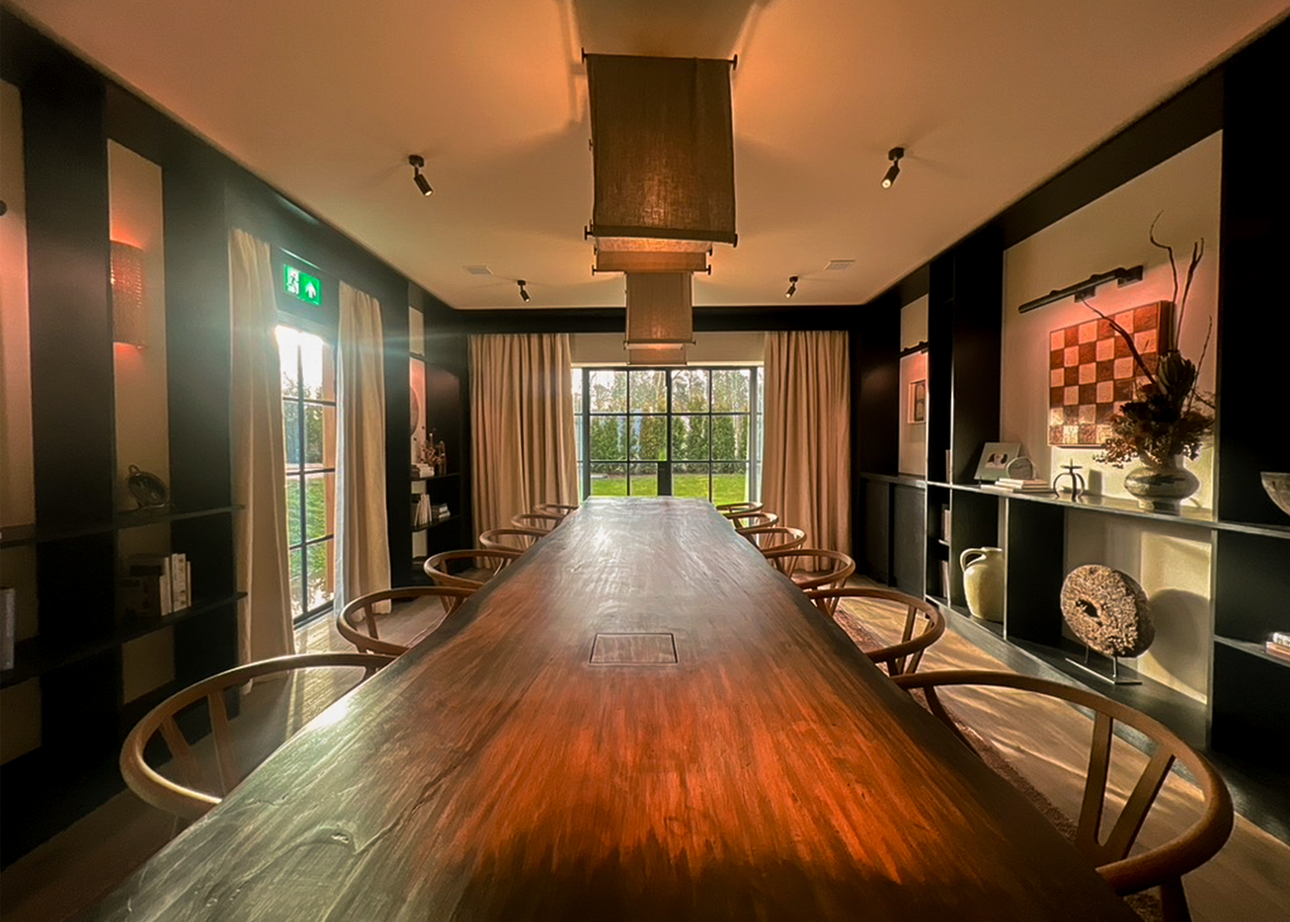 An meeting space featuring cabinetry and a long wooden table.
