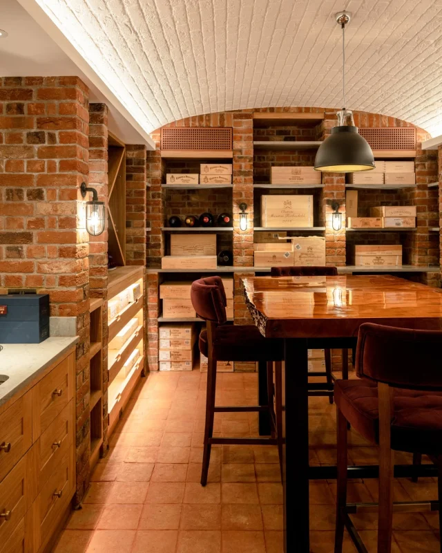 Solid oak joinery designed to sit seamlessly within the vaulted brickwork of this ambient wine cellar, incorporating bespoke shelving and illuminated drawers.  Get in touch with us to discuss your ideas – www.kingerleejoinery.co.uk  #WineCellar | #BespokeJoinery | #BespokeShelving
