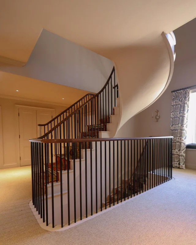 A striking centrepiece within this Gloucestershire residence, this recently completed staircase showcases our collaboration with the main contractor @cranattconstruction.The project included two bespoke curved staircases, rising from the ground floor to the first floor and continuing from the first floor to the second floor with a continuous handrail crafted from Walnut to introduce a contrasting natural feature.We are proud of this project and look forward to sharing more of our recently completed work from what has been a very busy first half of the year!#KingerleeJoinery #JoineryOxfordshire #BespokeStaircase #JoineryStaircase